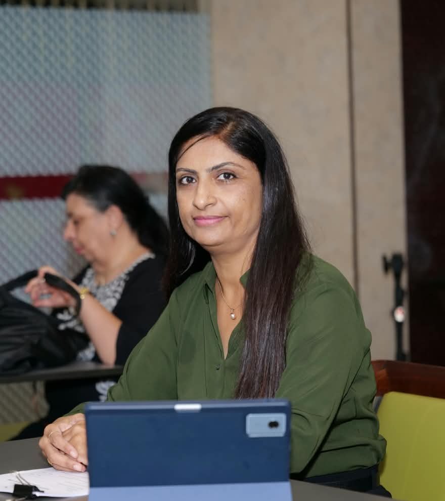 Asha Sheth, founder of Grow Root, at her desk during a client session